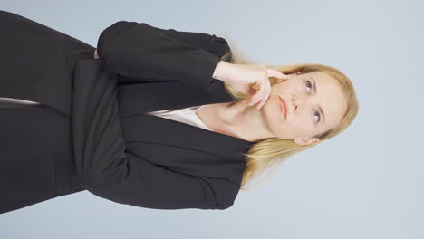 Vertical-video-of-Thoughtful-and-calculating-business-woman.